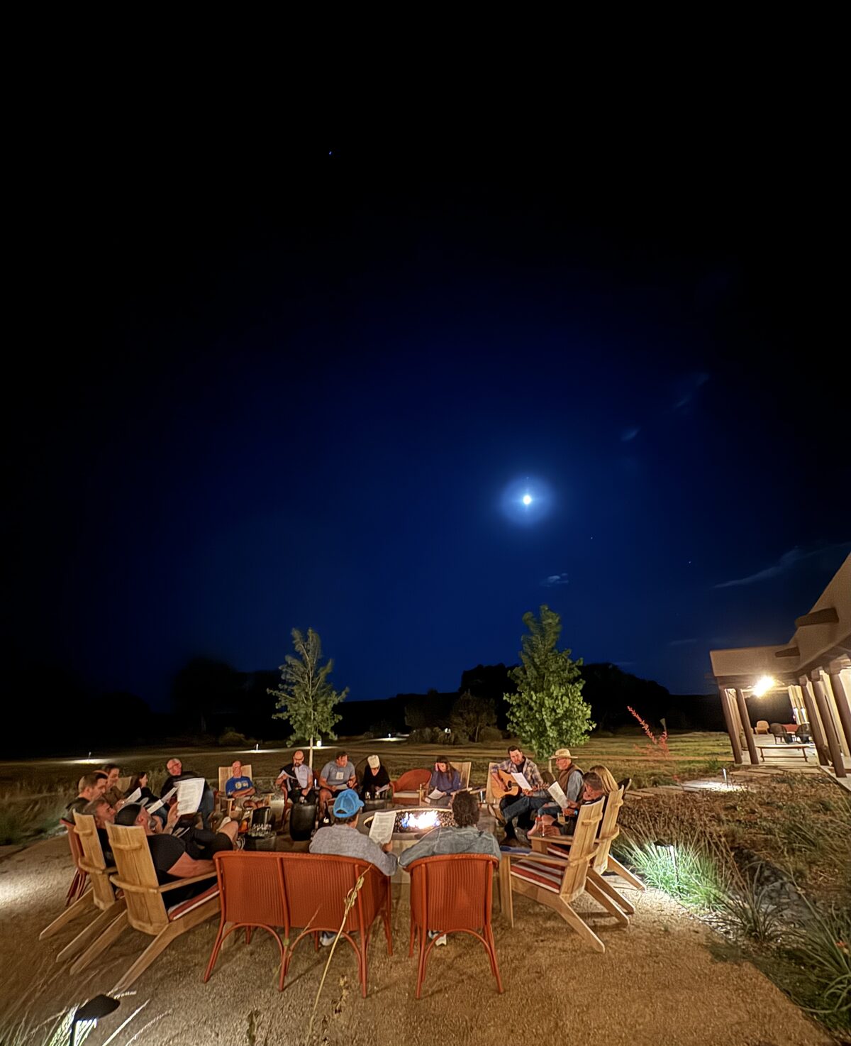 YPO New Mexico members gathered around a firepit under the night sky