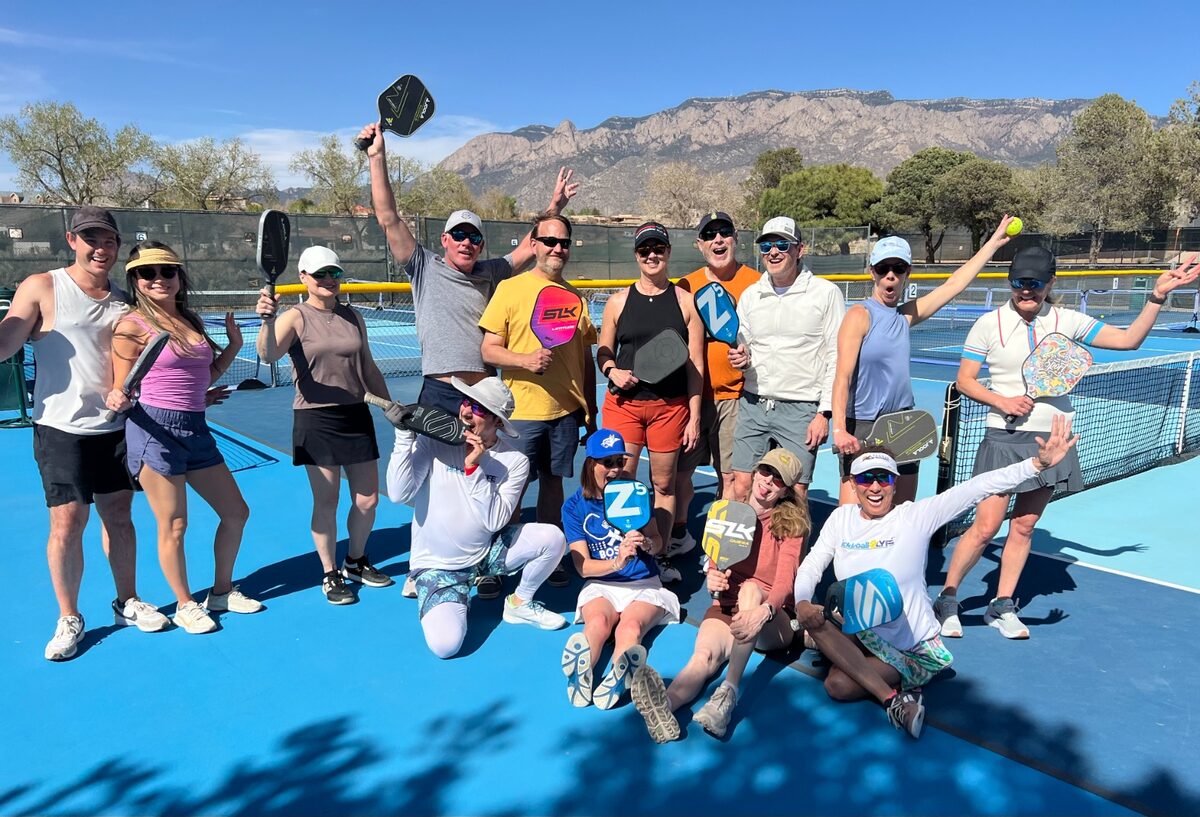 YPO New Mexico members playing pickleball with the Sandia Mountains in the background